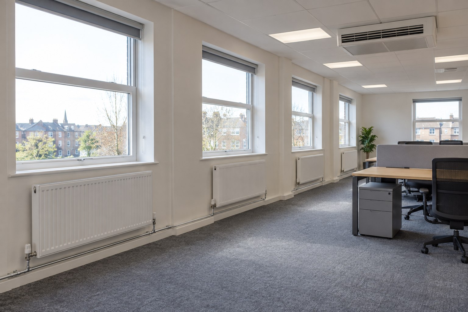New panel radiators and a fan convector in a refurbished office